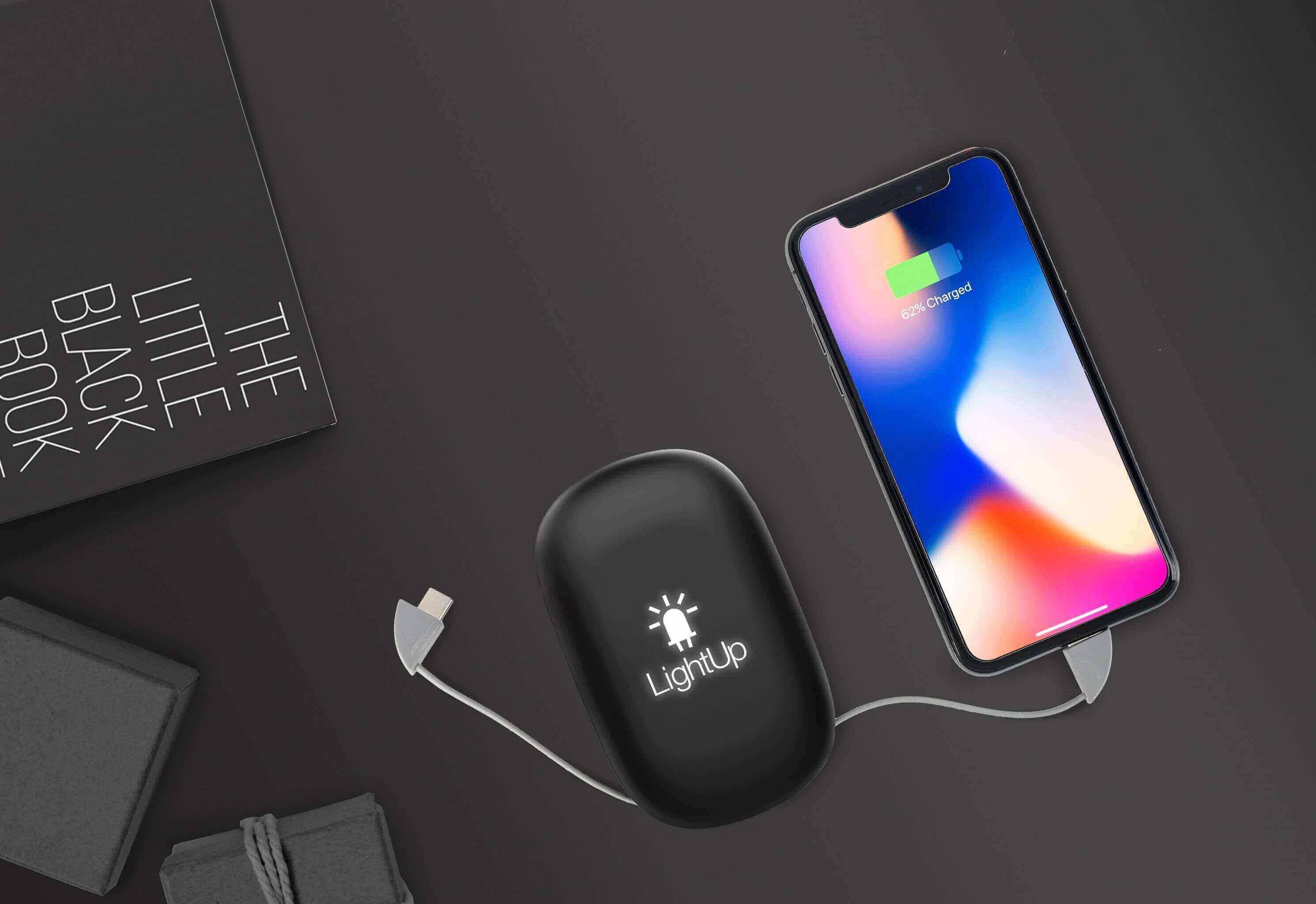 Power bank with a light up logo charging a mobile phone