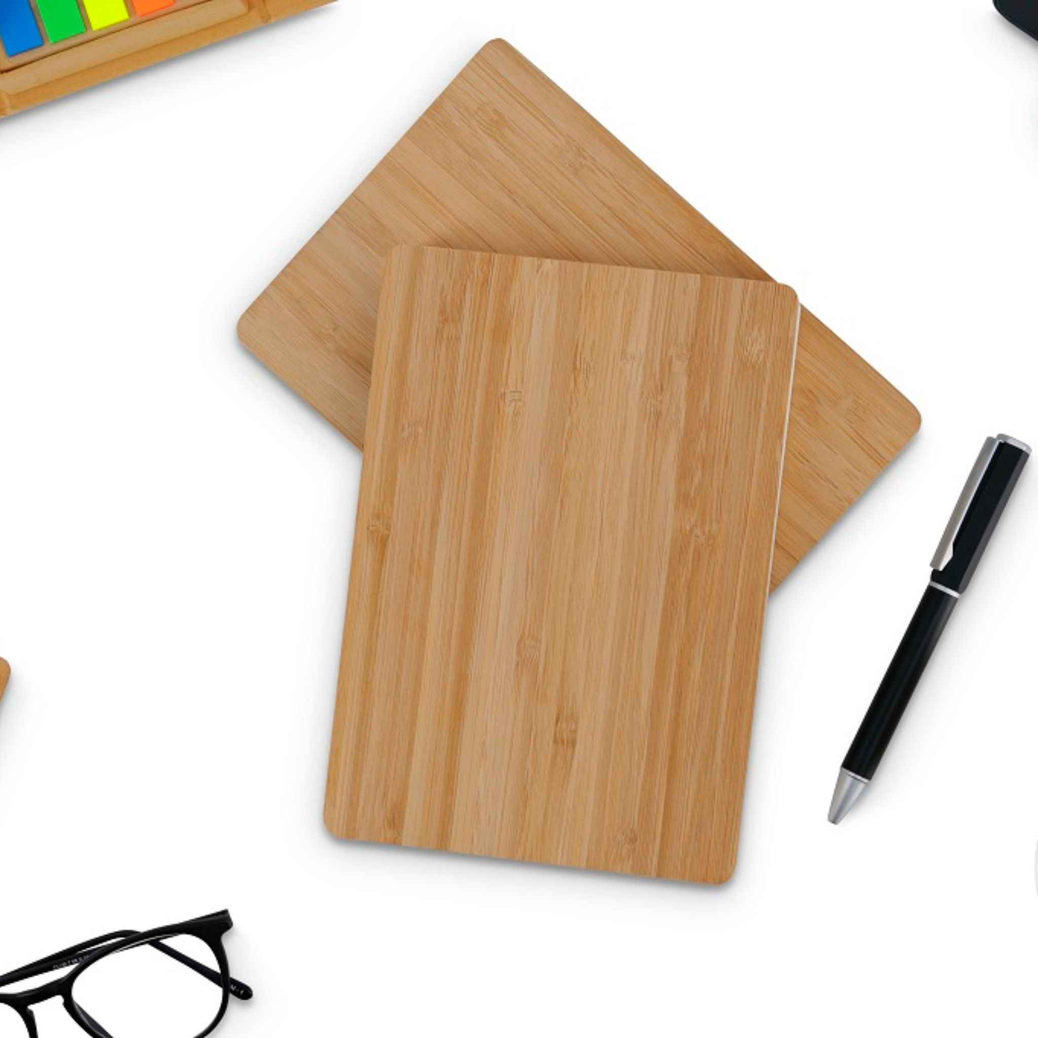 Two Bamboo Notebooks on a surface with office accessories