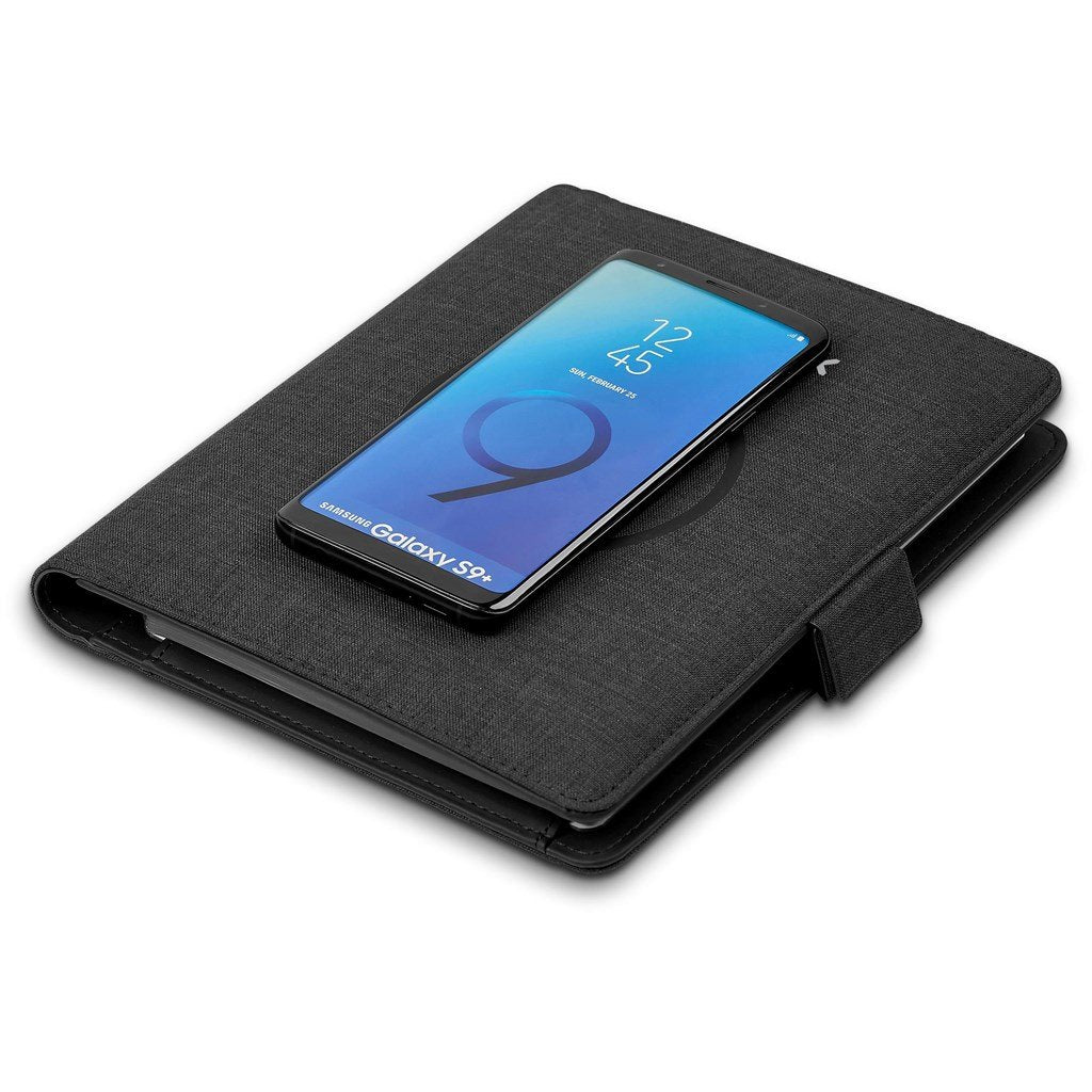 A padfolio showing its wireless phone charging feature in use.