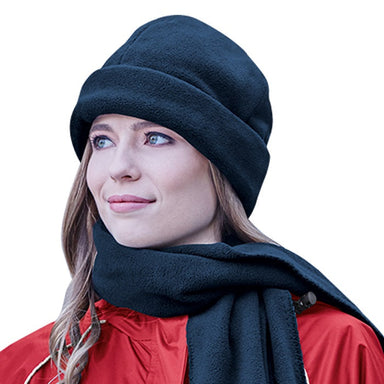 A Smiling lady wearing a polar fleece scarf and a beanie